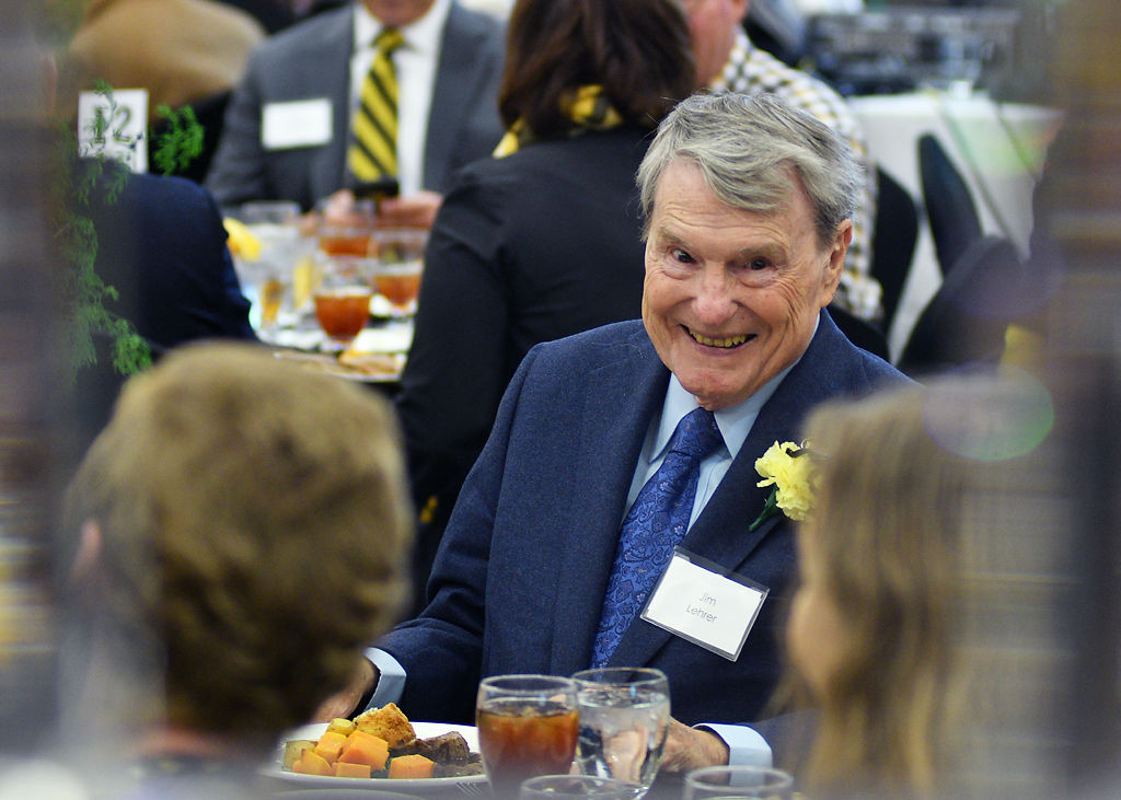 Jim Lehrer laughs with guests
